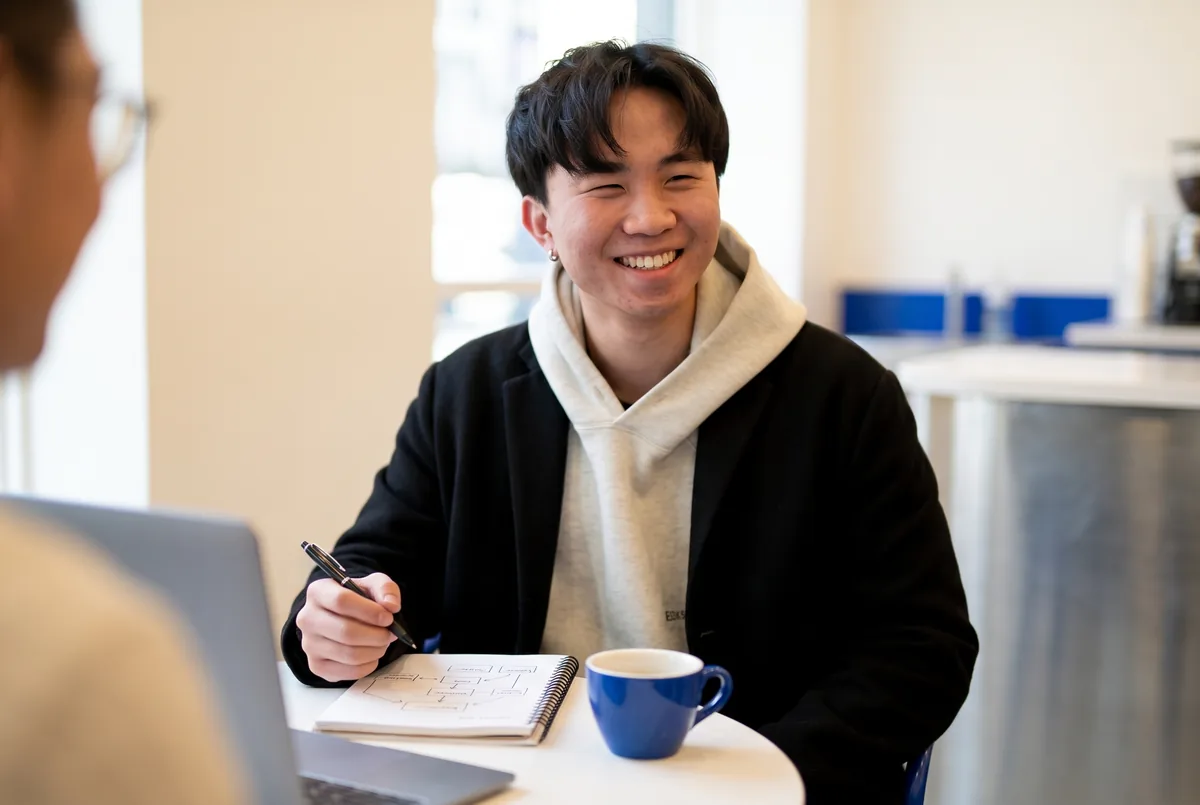 Ray Fu smiling across the table during a one-on-one consultation
